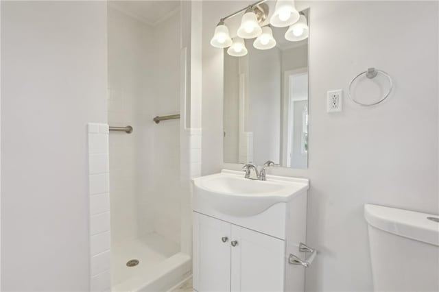 bathroom featuring vanity, toilet, and walk in shower