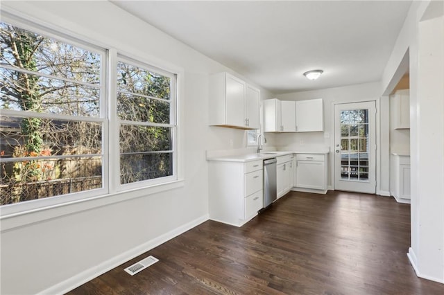 kitchen with white cabinetry, dishwasher, dark wood-type flooring, and sink