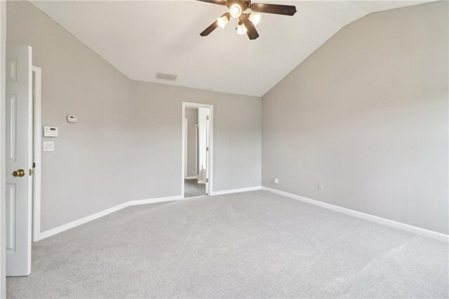 unfurnished bedroom featuring baseboards, carpet, and vaulted ceiling
