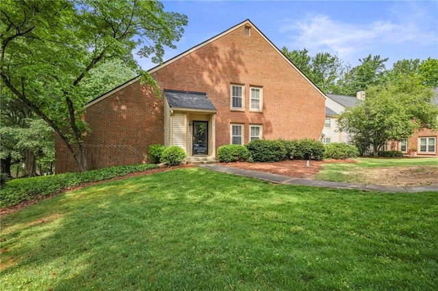 view of front facade featuring a front yard and brick siding