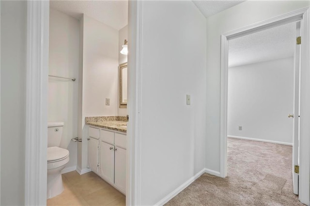 2117 Bucktrout Pl, Dunwoody, GA 30338 - bathroom with vanity, a textured ceiling, toilet, and baseboards