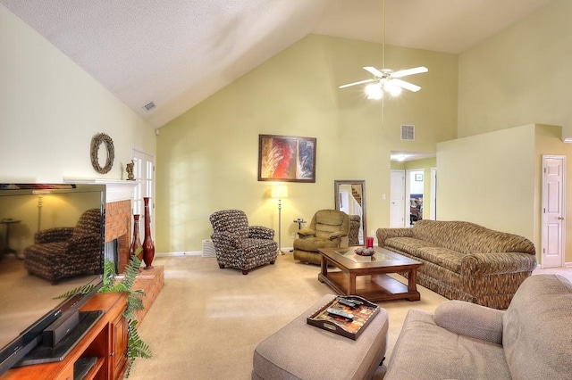 living area featuring carpet floors, visible vents, a fireplace, and high vaulted ceiling