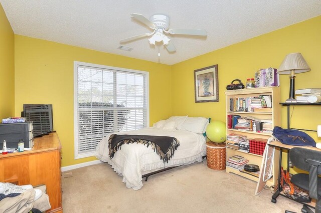 carpeted living area with a brick fireplace, visible vents, and french doors