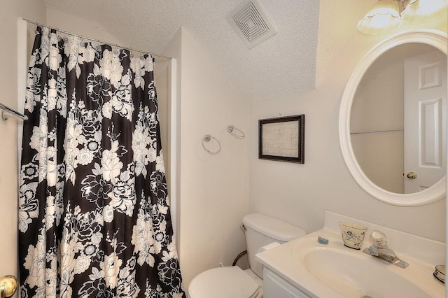 bathroom with a textured ceiling, toilet, a shower with shower curtain, vanity, and visible vents