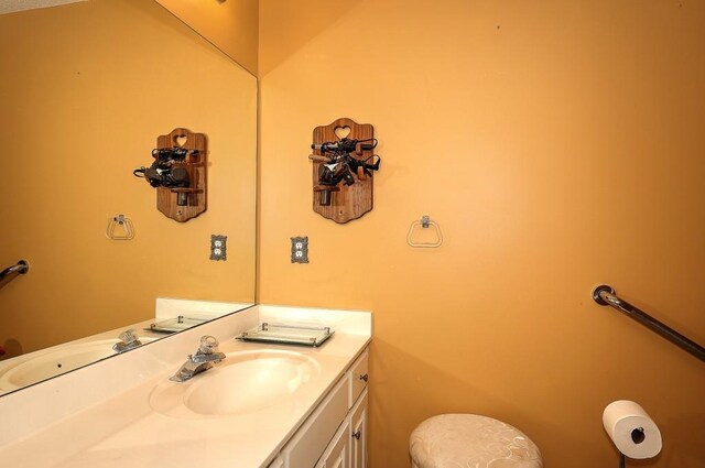 bathroom with a textured ceiling, toilet, vanity, visible vents, and shower / bath combination with curtain