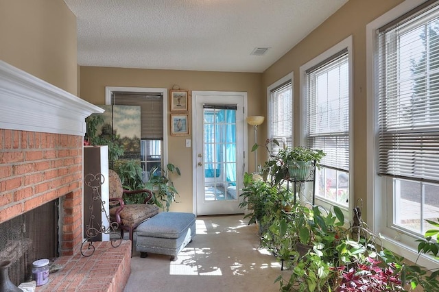 interior space with a fireplace, visible vents, and a textured ceiling