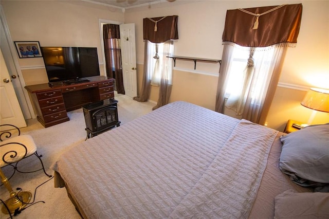 bedroom with crown molding and light colored carpet