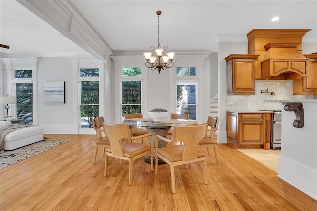 dining space with crown molding, baseboards, recessed lighting, light wood-style flooring, and an inviting chandelier