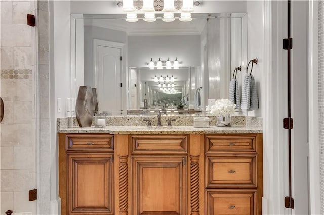 bathroom featuring vanity, a stall shower, and crown molding