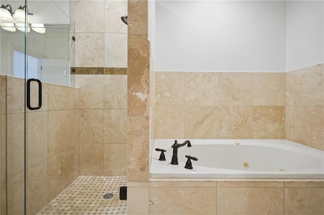 bathroom with a bath and a stall shower