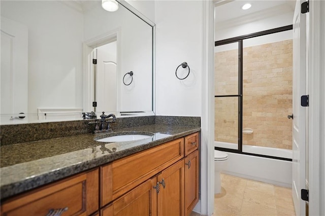 bathroom featuring recessed lighting, enclosed tub / shower combo, toilet, and vanity