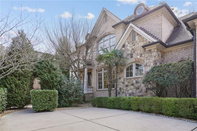 view of front facade with stone siding and brick siding