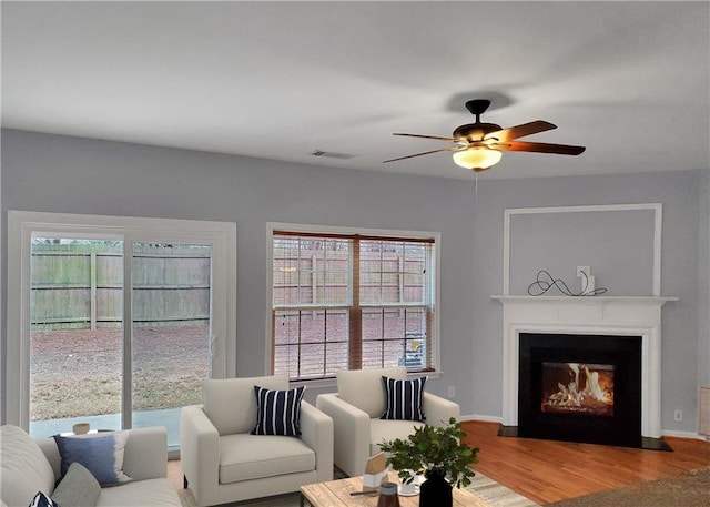 1649 Southgate Mill Dr, Duluth, GA 30096 - living area featuring wood finished floors, a ceiling fan, a fireplace with flush hearth, and baseboards