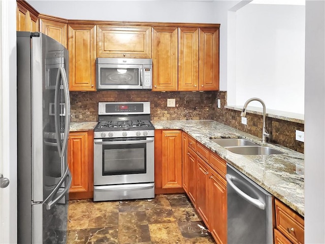 1649 Southgate Mill Dr, Duluth, GA 30096 - kitchen with appliances with stainless steel finishes, a sink, backsplash, and light stone countertops