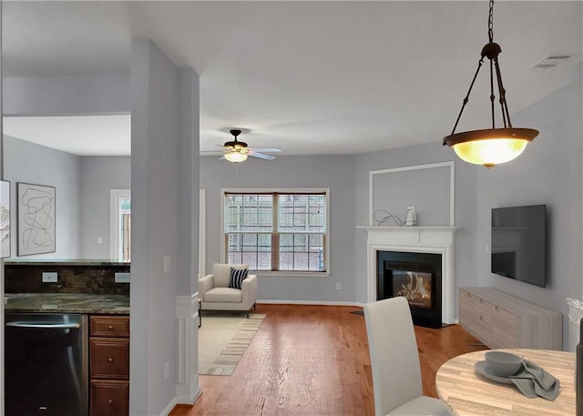 1649 Southgate Mill Dr, Duluth, GA 30096 - living room with a fireplace with flush hearth, light wood-style flooring, ceiling fan, and baseboards