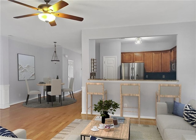1649 Southgate Mill Dr, Duluth, GA 30096 - living room with light wood-style flooring, ceiling fan, and baseboards