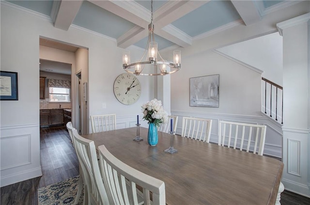 dining space with beam ceiling, a decorative wall, a notable chandelier, and dark wood-type flooring