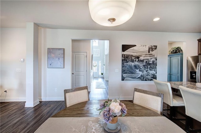 dining area with recessed lighting, dark wood-type flooring, and baseboards