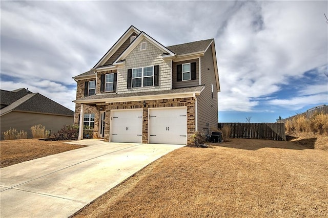 craftsman-style home featuring fence, a front yard, cooling unit, a garage, and driveway