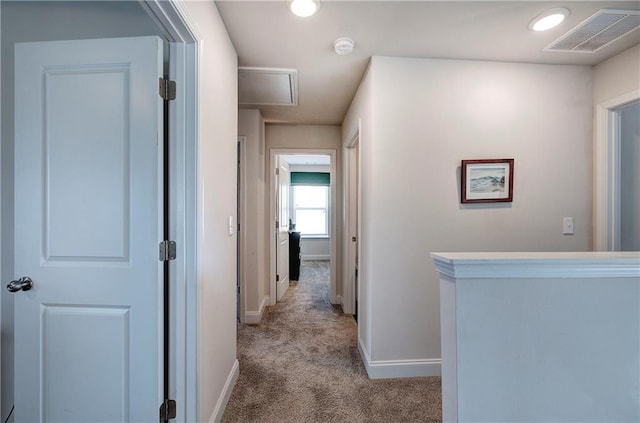 hall with carpet flooring, baseboards, and visible vents