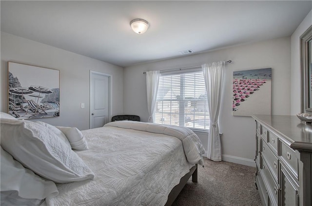 bedroom with baseboards, visible vents, and light carpet