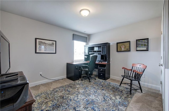 carpeted office featuring baseboards