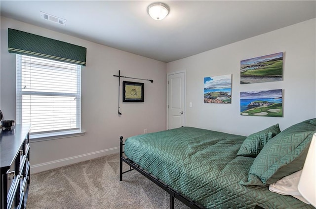 carpeted bedroom with baseboards and visible vents