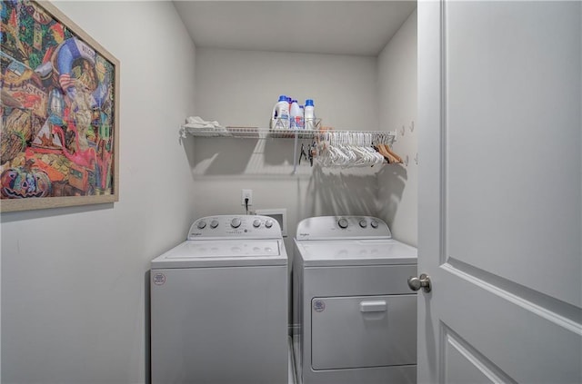 laundry room featuring separate washer and dryer and laundry area