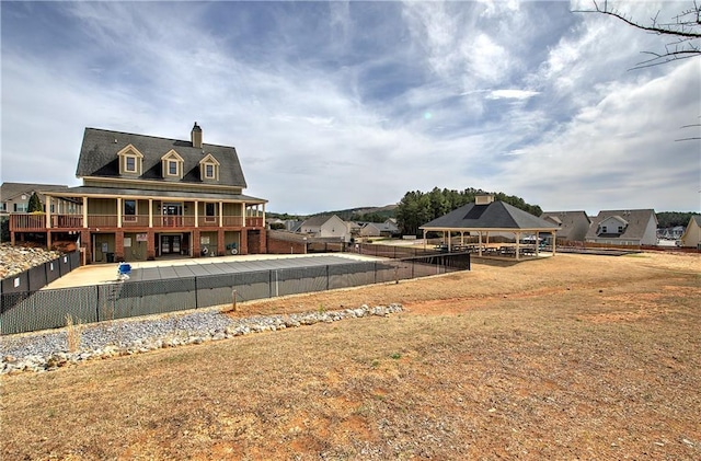 exterior space with a gazebo and a fenced backyard