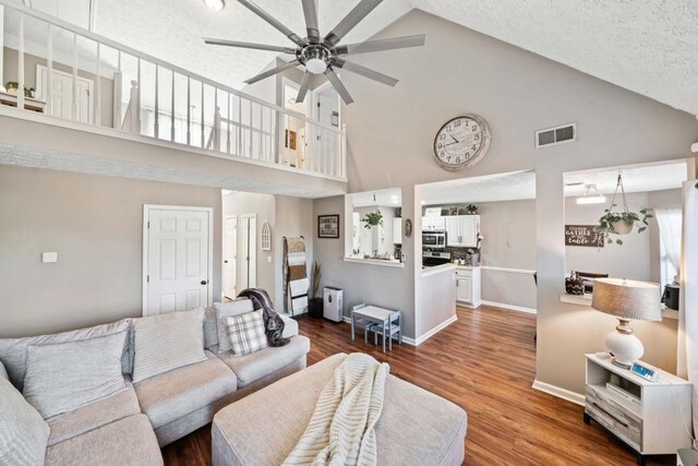 565 Saint James Ct, Lawrenceville, GA 30044 - living room featuring high vaulted ceiling, dark wood-type flooring, a textured ceiling, and ceiling fan