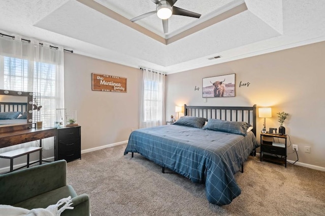 565 Saint James Ct, Lawrenceville, GA 30044 - carpeted bedroom featuring crown molding, a textured ceiling, and a tray ceiling