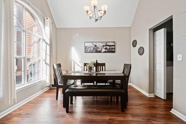 565 Saint James Ct, Lawrenceville, GA 30044 - dining room with vaulted ceiling, an inviting chandelier, and dark hardwood / wood-style flooring