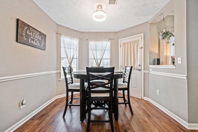 565 Saint James Ct, Lawrenceville, GA 30044 - dining space with dark wood-type flooring and a textured ceiling