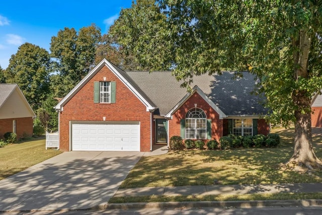 view of front of property featuring a front yard and a garage