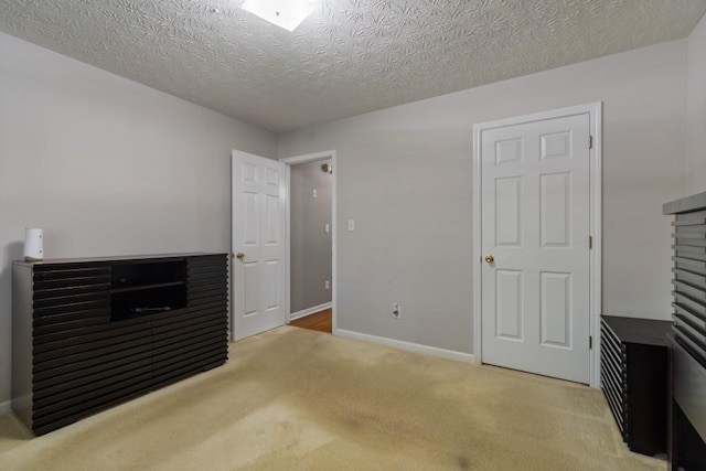 interior space with a textured ceiling and carpet