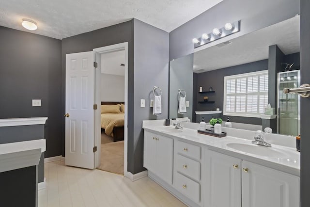 bathroom with vanity and a textured ceiling