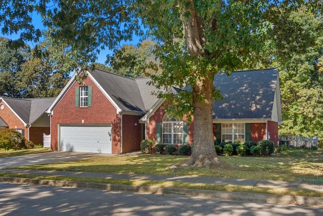 view of front of property featuring a front yard and a garage