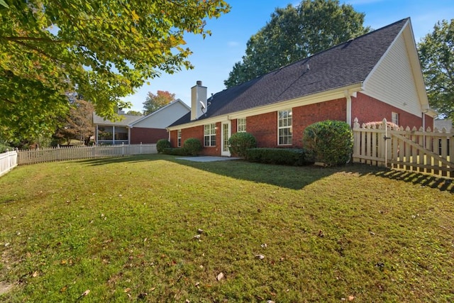 back of house featuring a lawn