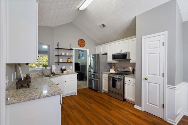 kitchen featuring appliances with stainless steel finishes, white cabinets, sink, and dark hardwood / wood-style floors