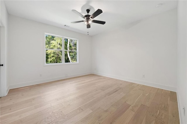 empty room with ceiling fan and light wood-type flooring