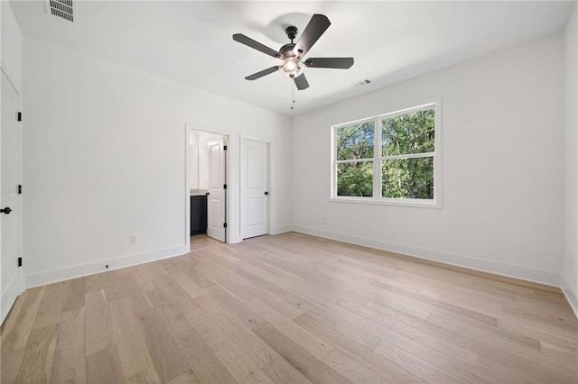 unfurnished bedroom with ensuite bath, ceiling fan, and light wood-type flooring