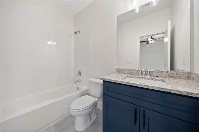 full bathroom with tiled shower / bath, tile patterned flooring, vanity, ceiling fan, and toilet