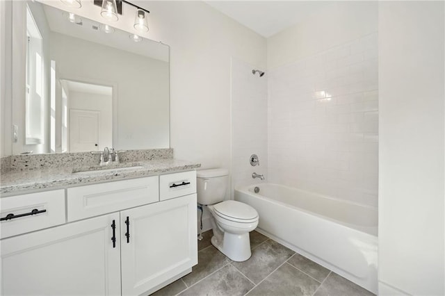 full bathroom featuring tiled shower / bath combo, vanity, tile patterned floors, and toilet