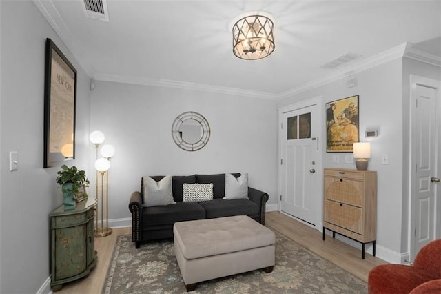 living room featuring crown molding, wood finished floors, and visible vents