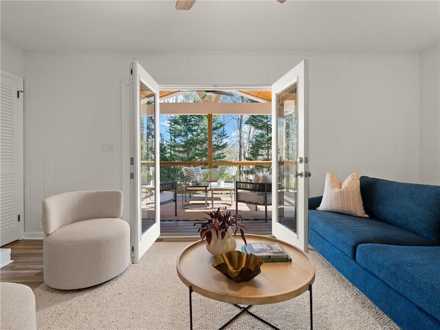 living area with french doors and wood finished floors