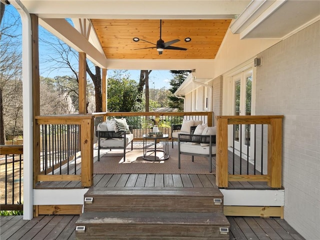 deck featuring outdoor lounge area and a ceiling fan