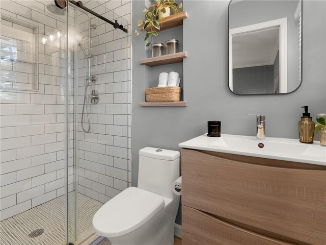 bathroom featuring vanity, a shower stall, and toilet