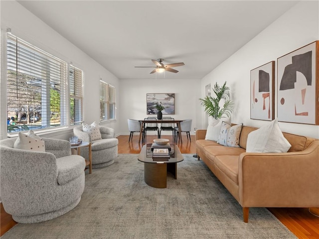 living room featuring a ceiling fan and wood finished floors