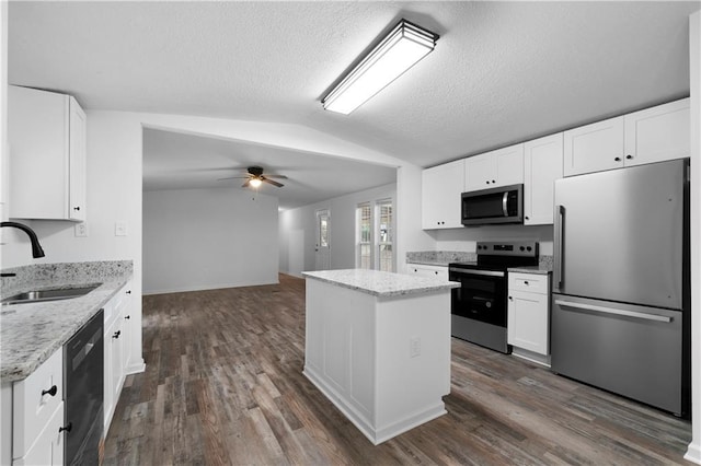 68 Wagon Trail Cir, Dallas, GA 30132 - kitchen with stainless steel appliances, vaulted ceiling, a center island, ceiling fan, and white cabinets
