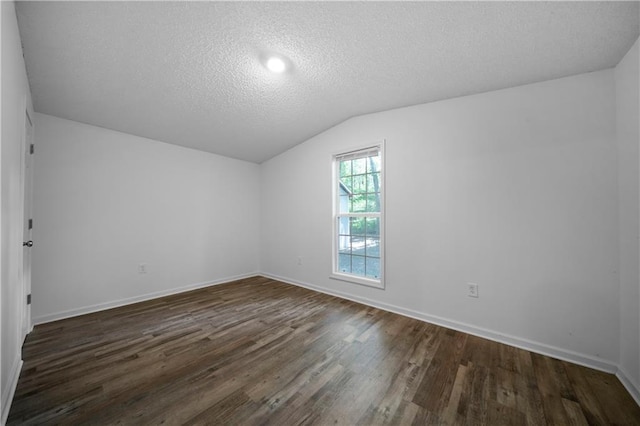68 Wagon Trail Cir, Dallas, GA 30132 - bonus room with lofted ceiling, dark wood finished floors, and a textured ceiling